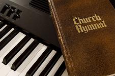 Church Hymnal resting on a keyboard
