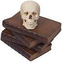 Human Skull on leather-bound books
